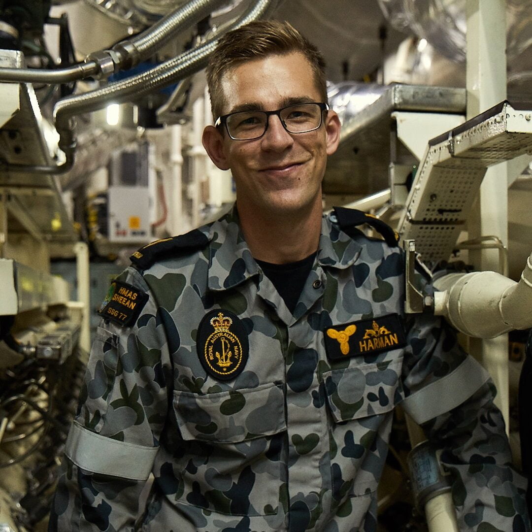 Marine Technician Submariner Cooper smiles at camera.