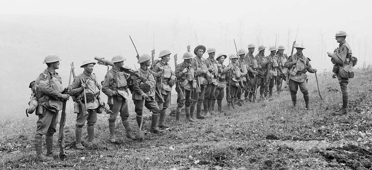 A large group of Army members standing outside in a line in black and white.