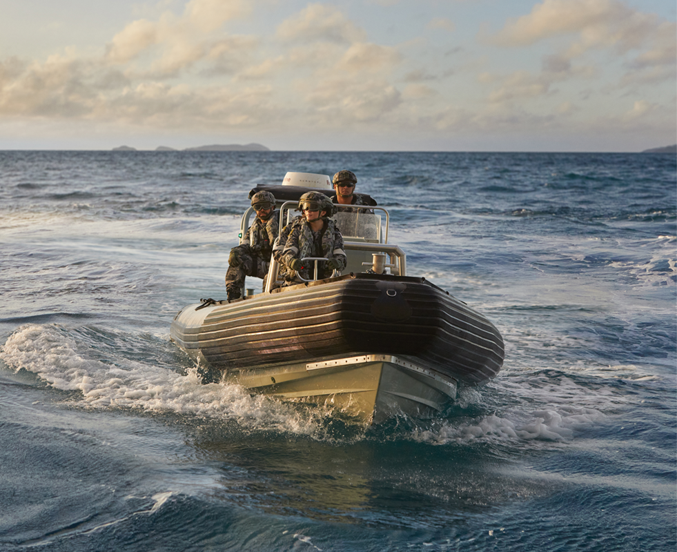 Four members of the Navy in a boat.