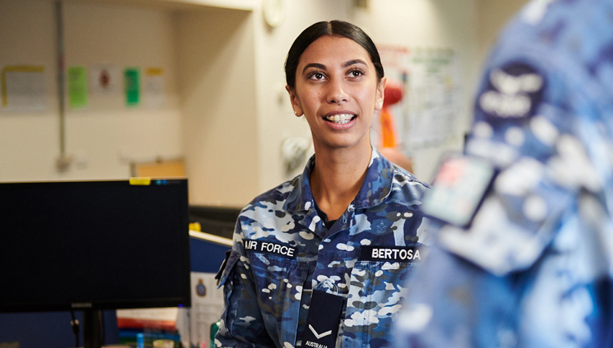 A member of the Air Force stands in her office.