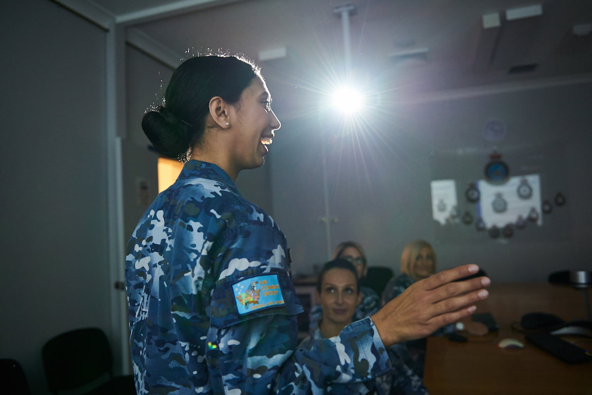 A female soldier presenting in military attire.