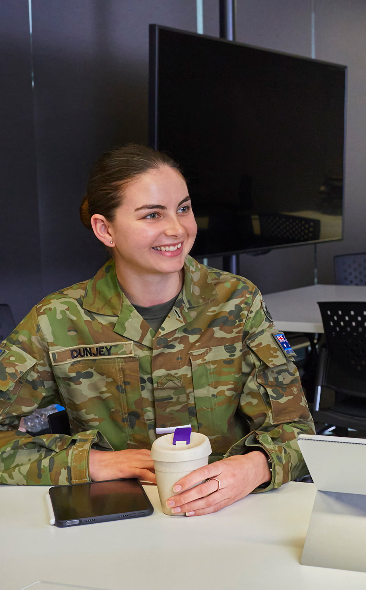 Woman in army uniform works in a lab.